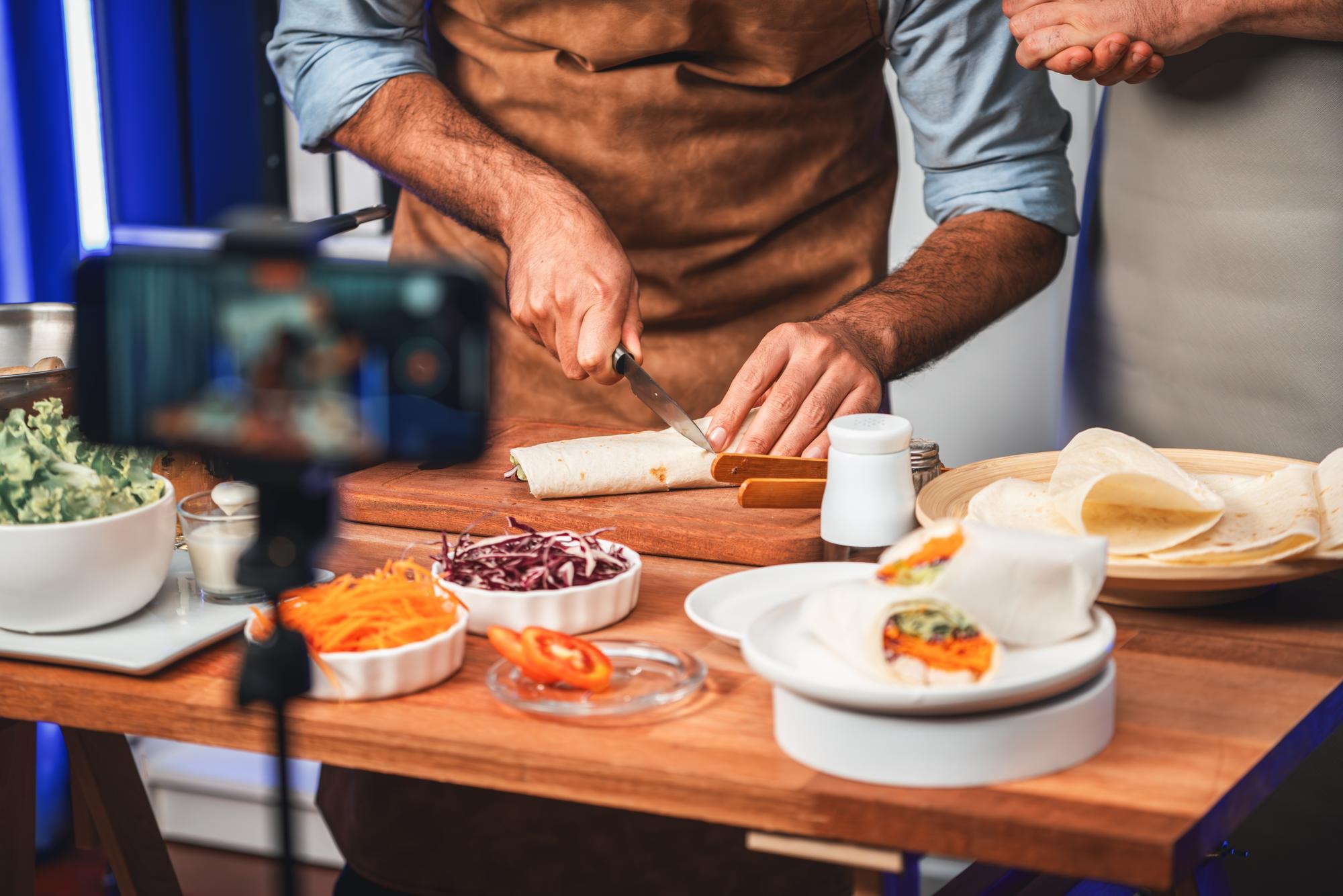 Chef arranging plated tasting menu on workbench